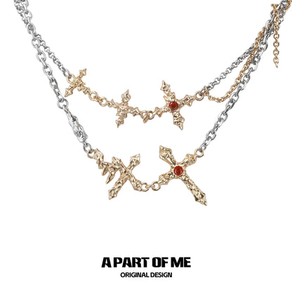 A PART OF ME liquid metal cross necklace in silver with intricate designs and red accents