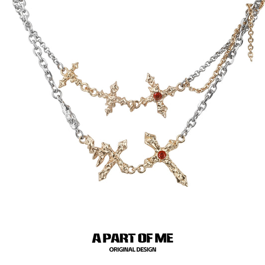 A PART OF ME liquid metal cross necklace in silver with intricate designs and red accents