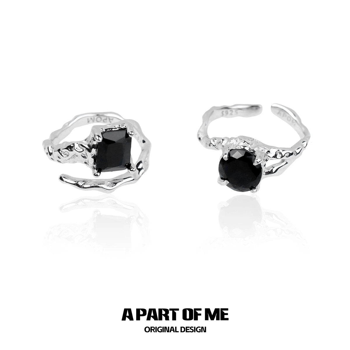 A pair of A PART OF ME midnight gem couple rings featuring black gemstones in a stylish twisted design