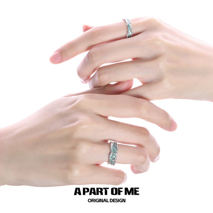 A mint silver ring elegantly displayed on two hands showcasing its unique design and polished finish