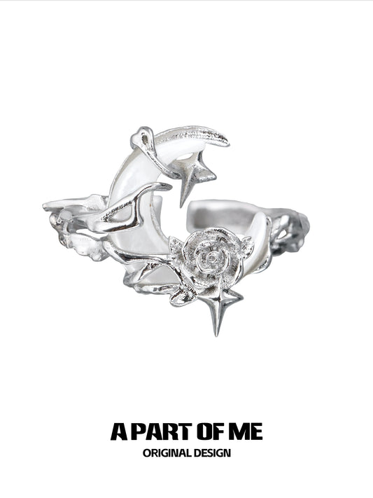 A beautiful moonlight rose silver ring featuring intricate star and rose designs