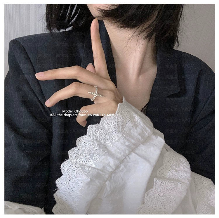 A model showcasing a redemption cross silver ring with stylish attire, emphasizing elegance