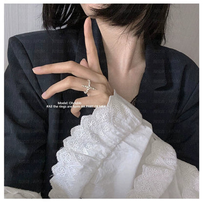 A model showcasing a redemption cross silver ring with stylish attire, emphasizing elegance
