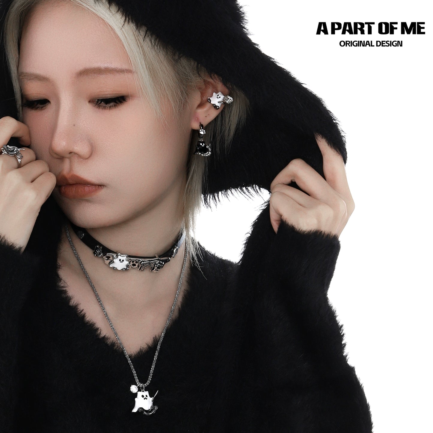 A PART OF ME weapon kitten devil necklace displayed on a model wearing a black hooded sweater