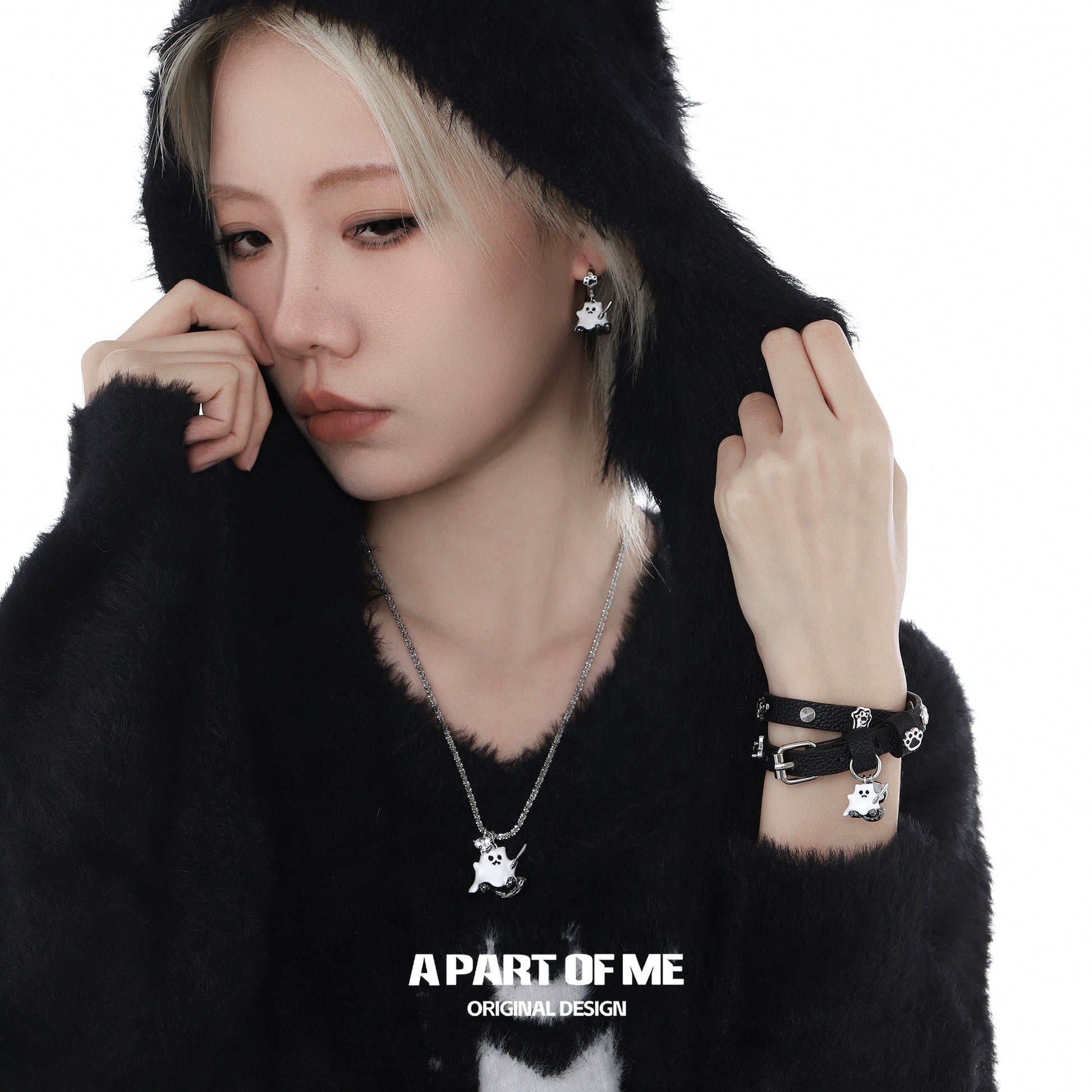 A PART OF ME weapon kitten devil necklace showcasing a playful design on a model wearing a cozy black hoodie