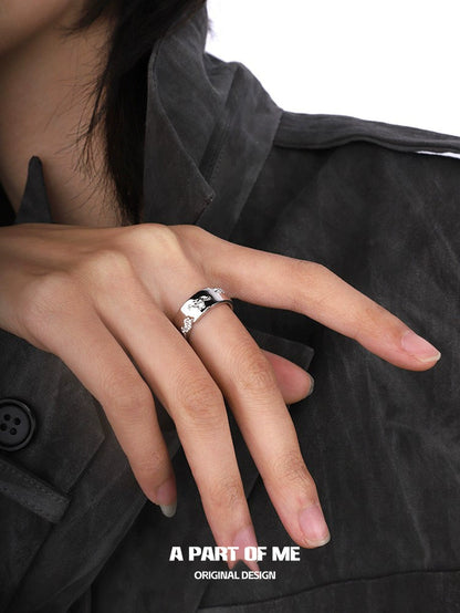 Silver broken galaxy couple rings displayed on a hand with stylish attire