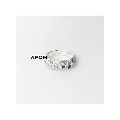 A Part of Me blue gemstone silver ring with intricate design and two blue stones