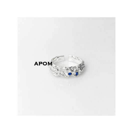 A Part of Me blue gemstone silver ring with intricate design and two blue stones