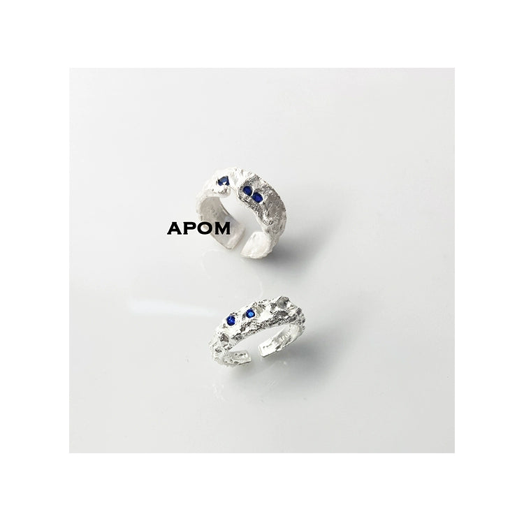 A PART OF ME blue gemstone silver ring featuring a textured band and blue stone accents