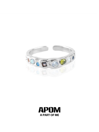 A PART OF ME rainbow gemstone ring featuring multiple colorful gemstones in a sleek silver band