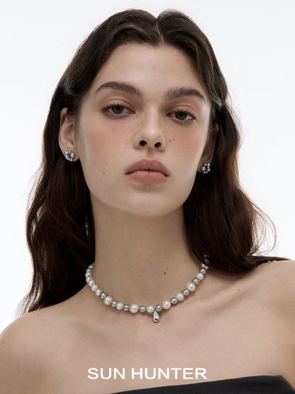 Elegant model wearing black agate earrings paired with a pearl necklace for a sophisticated look