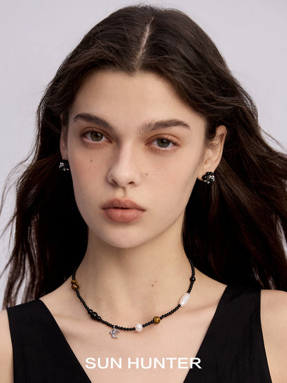 Elegant black agate earrings paired with a beaded necklace for a stylish look