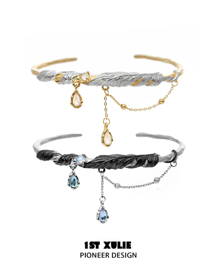 Stylish black and gold feather couple bracelet featuring elegant design and dangling gemstones