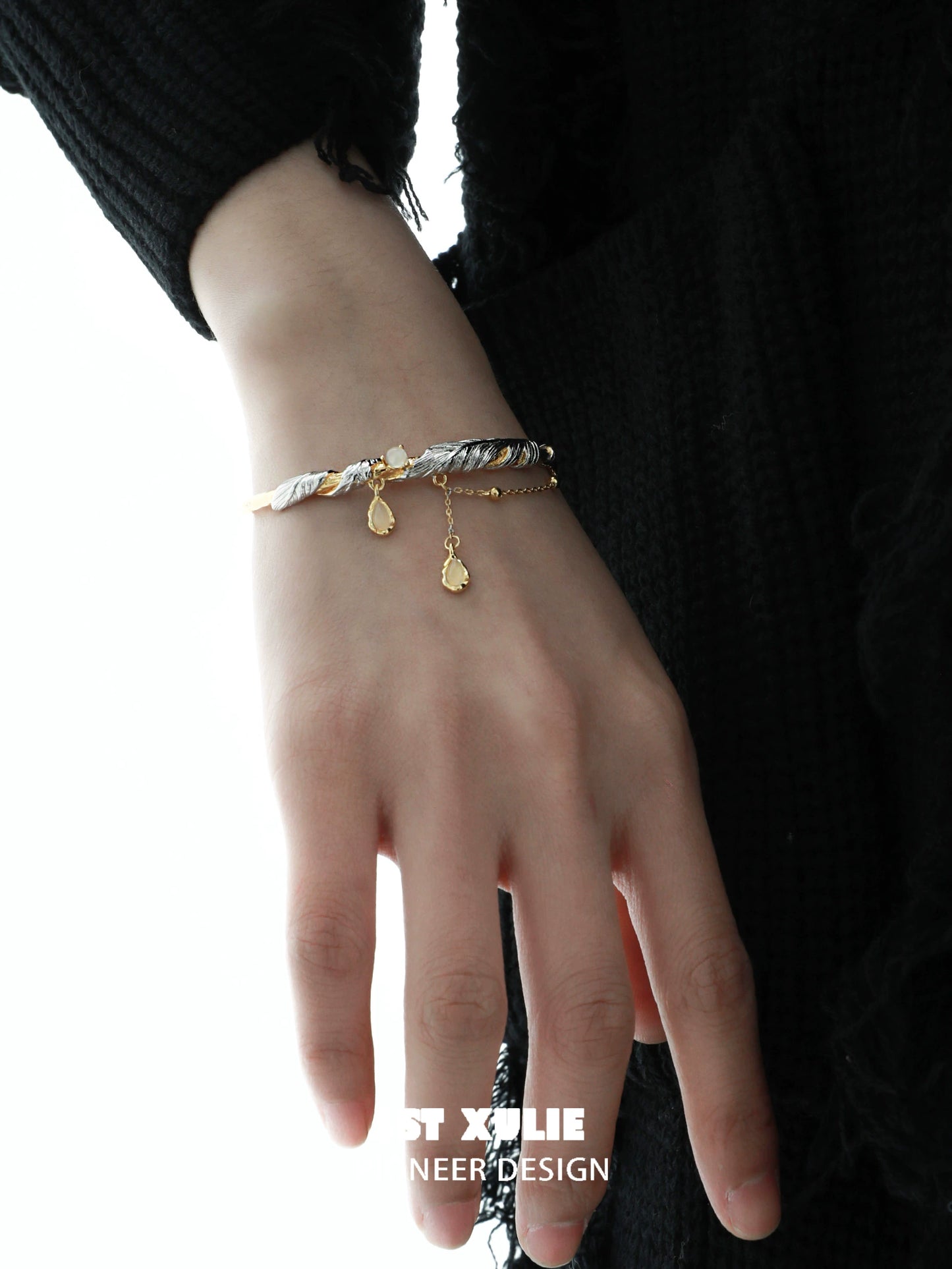 Stylish black and gold feather couple bracelet featuring elegant charm details