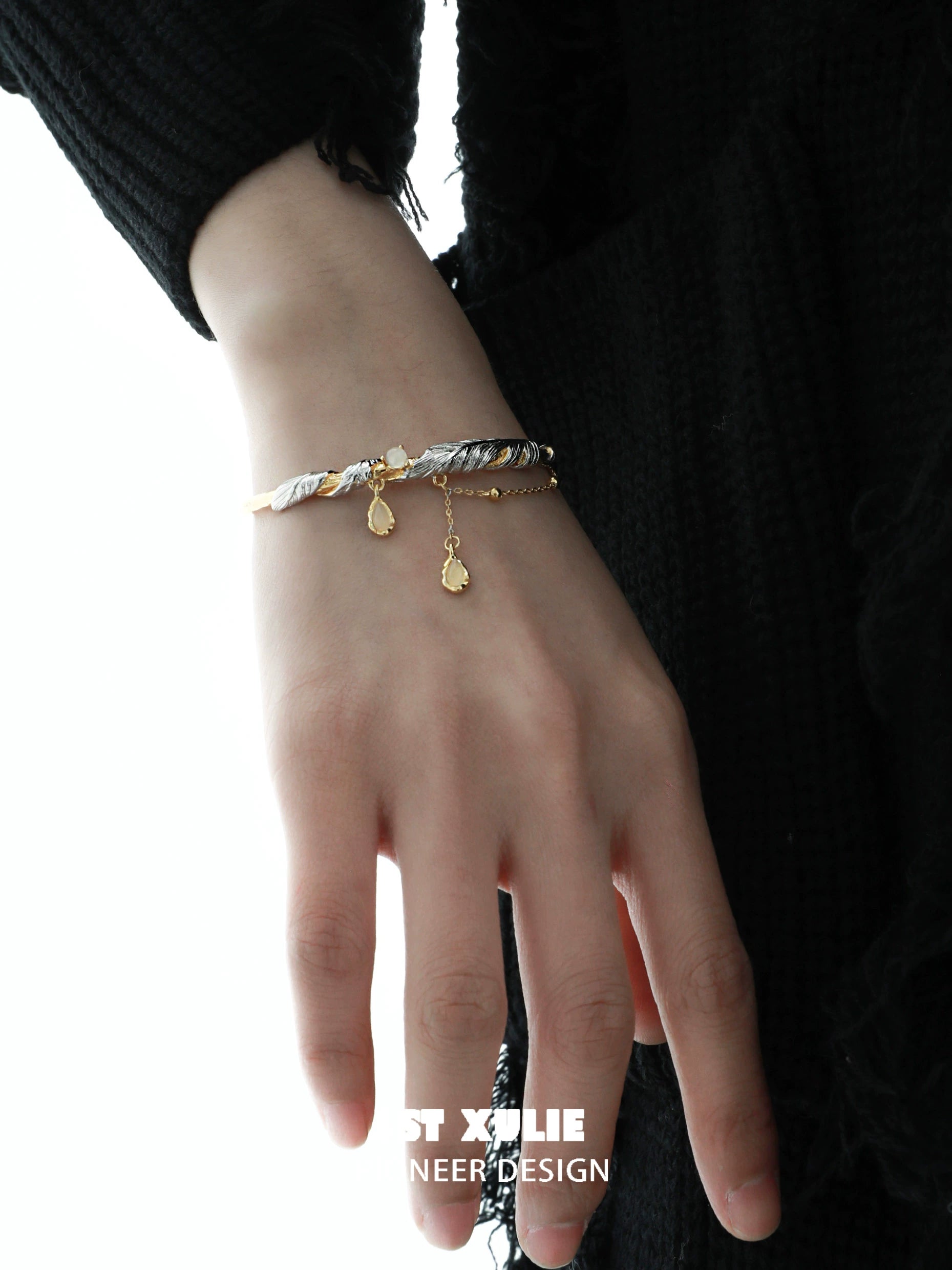 Stylish black and gold feather couple bracelet featuring elegant charm details