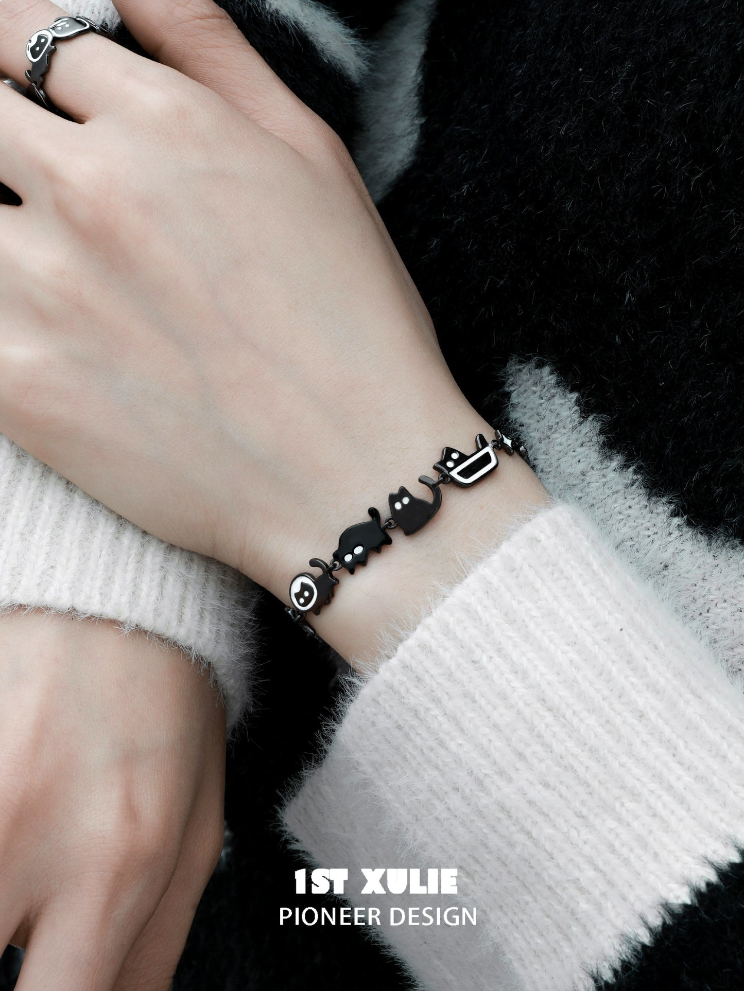 Stylish black cat bracelet featuring playful cat and fish charms, perfect for cat lovers