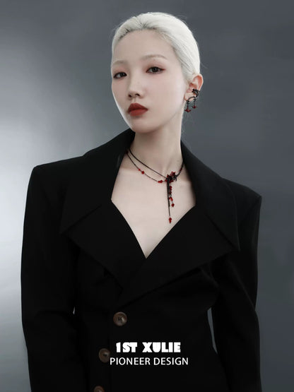 Elegant model wearing a blood mandala tassel necklace with intricate design and red accents