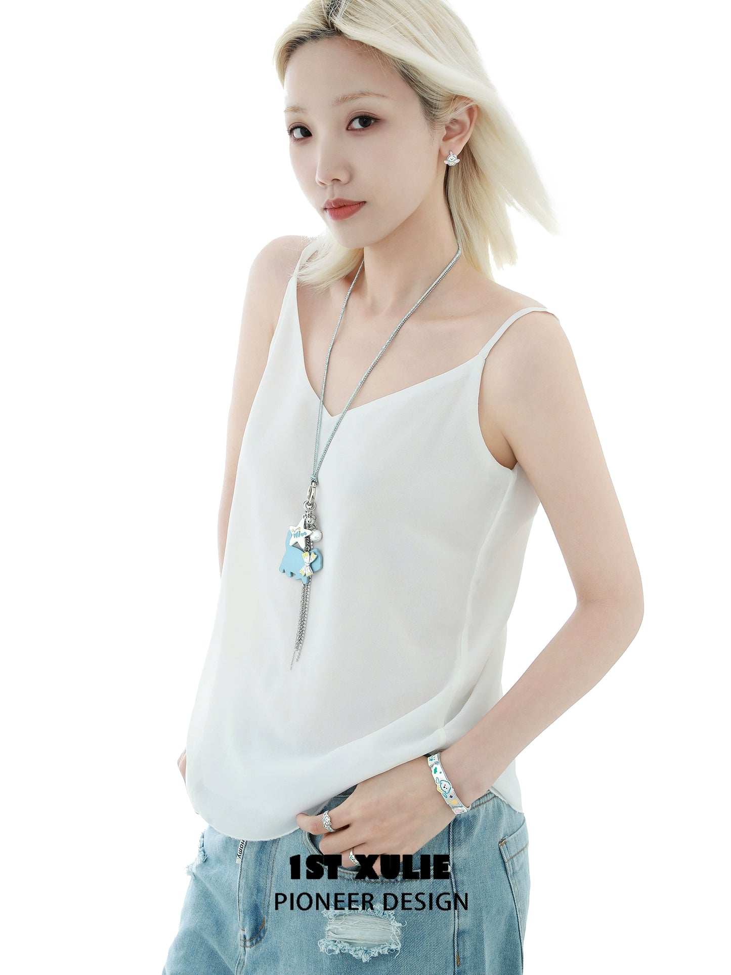 Stylish model wearing a blue cat keychain necklace alongside casual summer attire