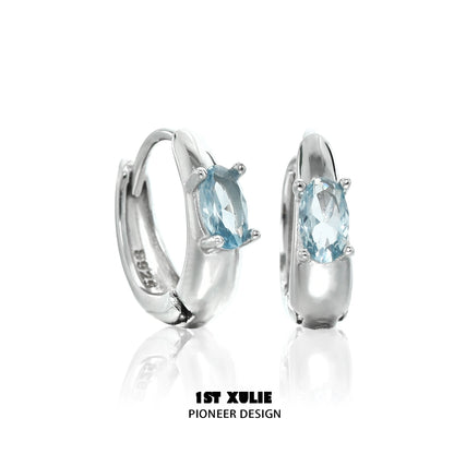Elegant blue cosmic earrings with sparkling gemstone set in shiny silver hoop design