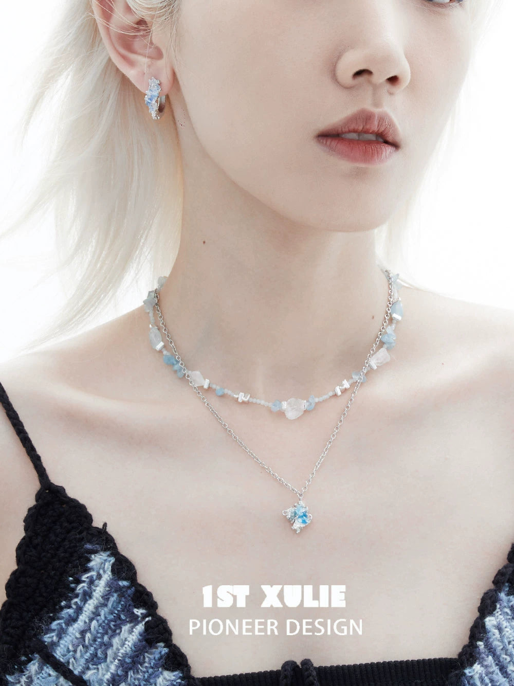 Stylish model wearing blue crystal ear cuffs paired with matching jewelry for a chic look