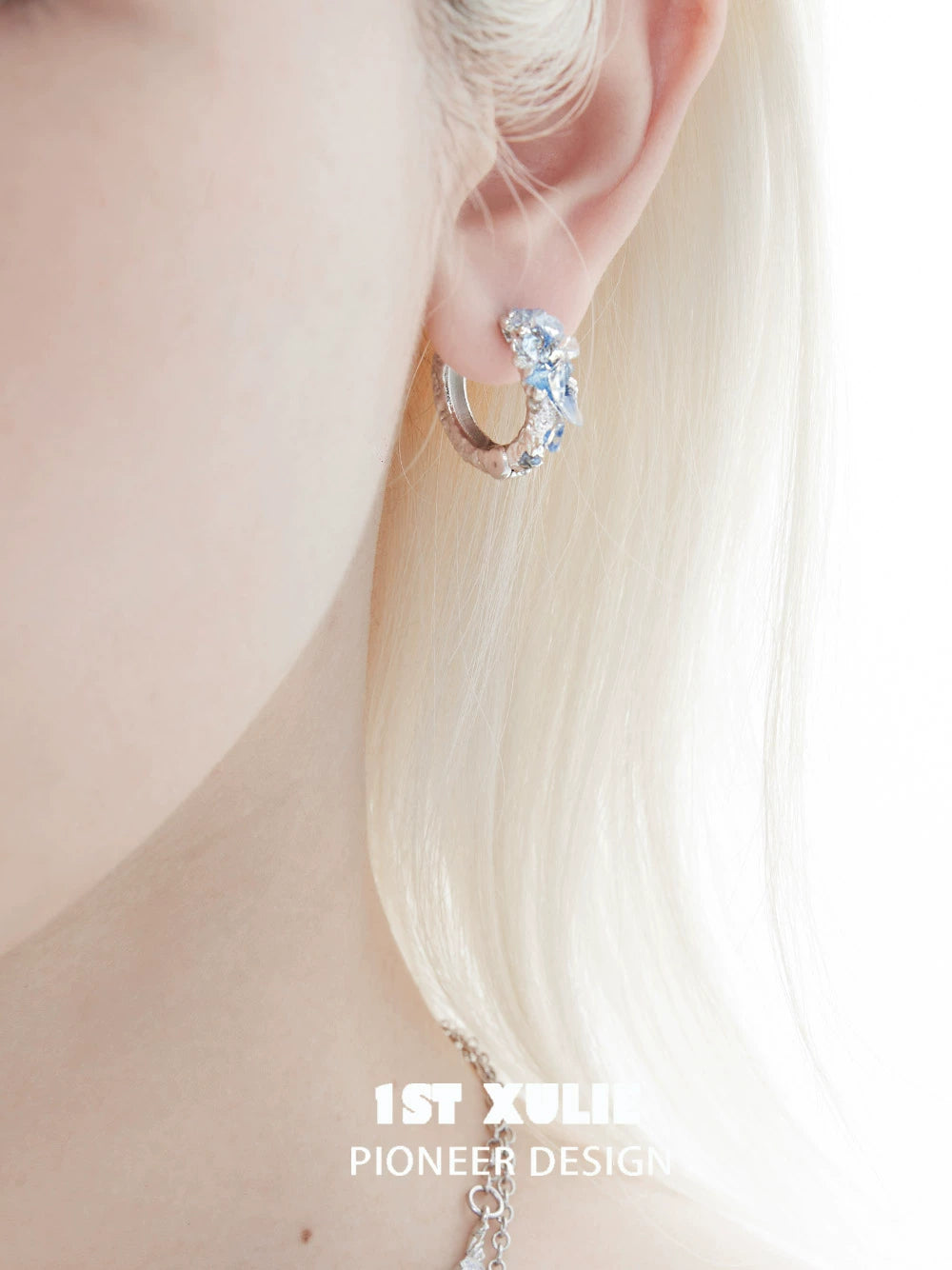 Elegant blue crystal ear cuffs from 1STXULIE showcasing a unique design and sparkle