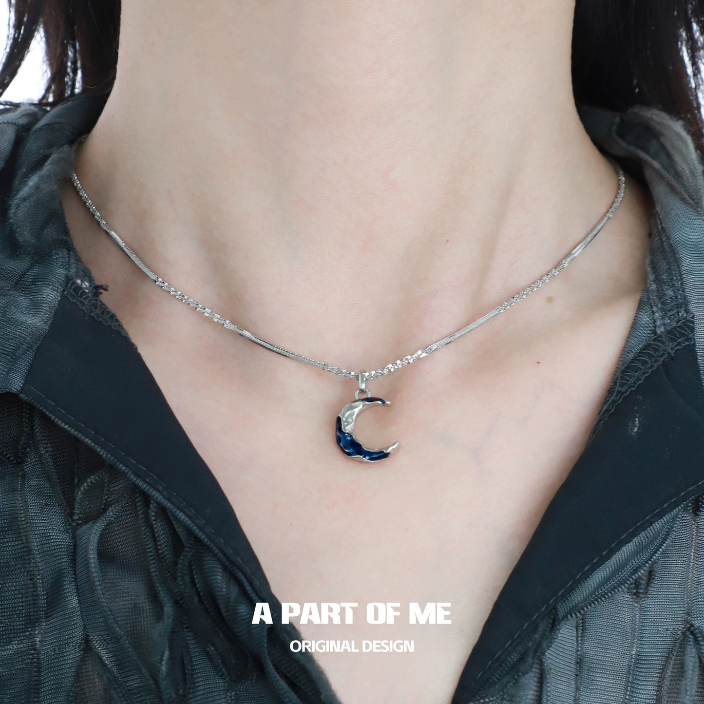 Elegant blue moon pendant necklace from A PART OF ME featuring a silver chain and crescent moon design