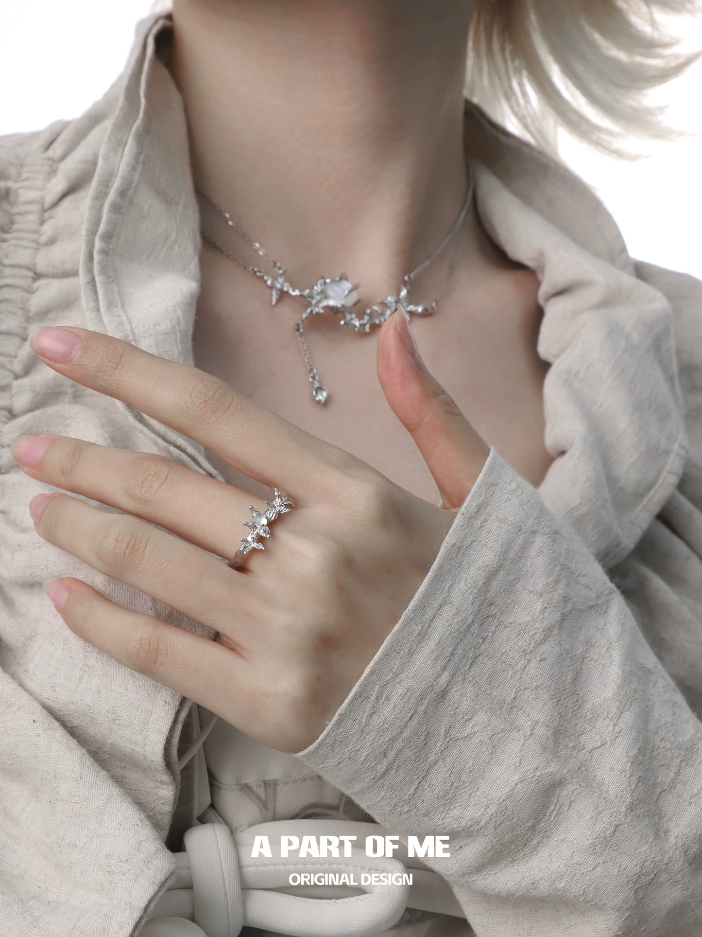 Elegant butterfly agate ring showcased on a hand, complementing a delicate necklace and styled outfit