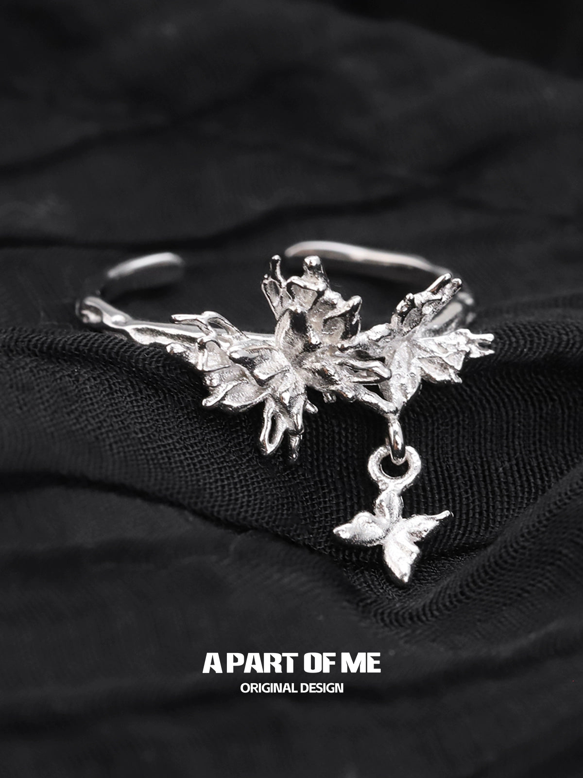 A PART OF ME butterfly charm silver ring featuring intricate floral designs and a delicate butterfly pendant