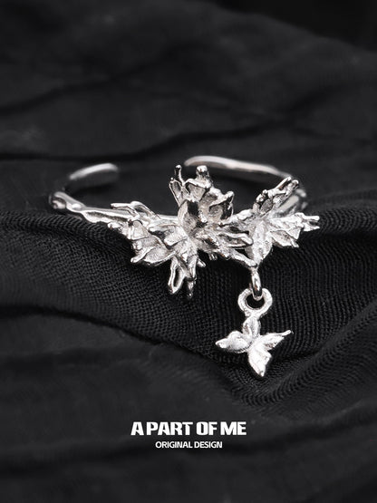 A PART OF ME butterfly charm silver ring featuring intricate floral designs and a delicate butterfly pendant