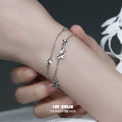 Butterfly double chain bracelet designed by 1STXULIE with delicate butterfly charms on a silver chain