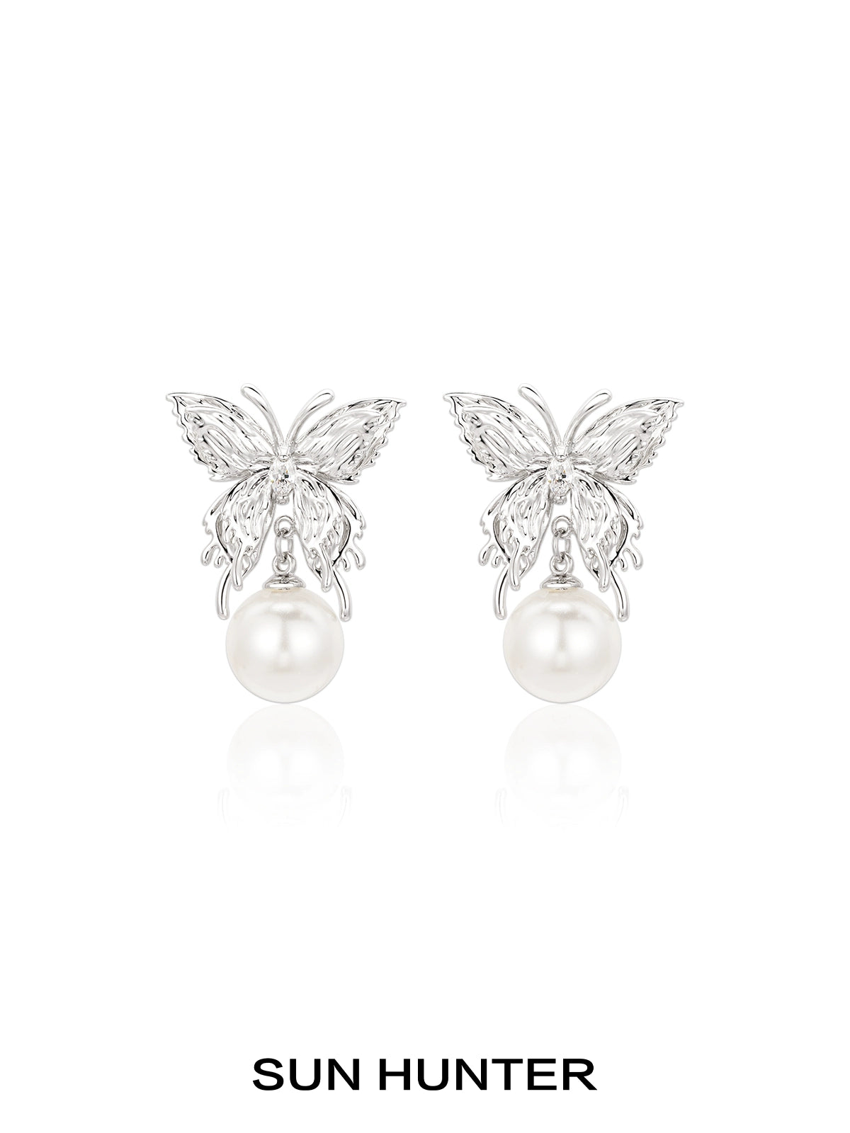 Elegant SUN HUNTER butterfly pearl earrings featuring a silver butterfly design and lustrous pearls
