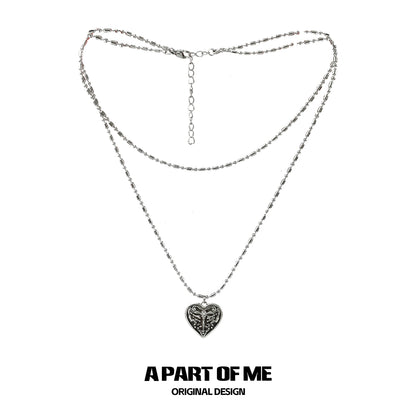 Butterfly punk necklace with layered silver chains and a heart pendant for edgy style