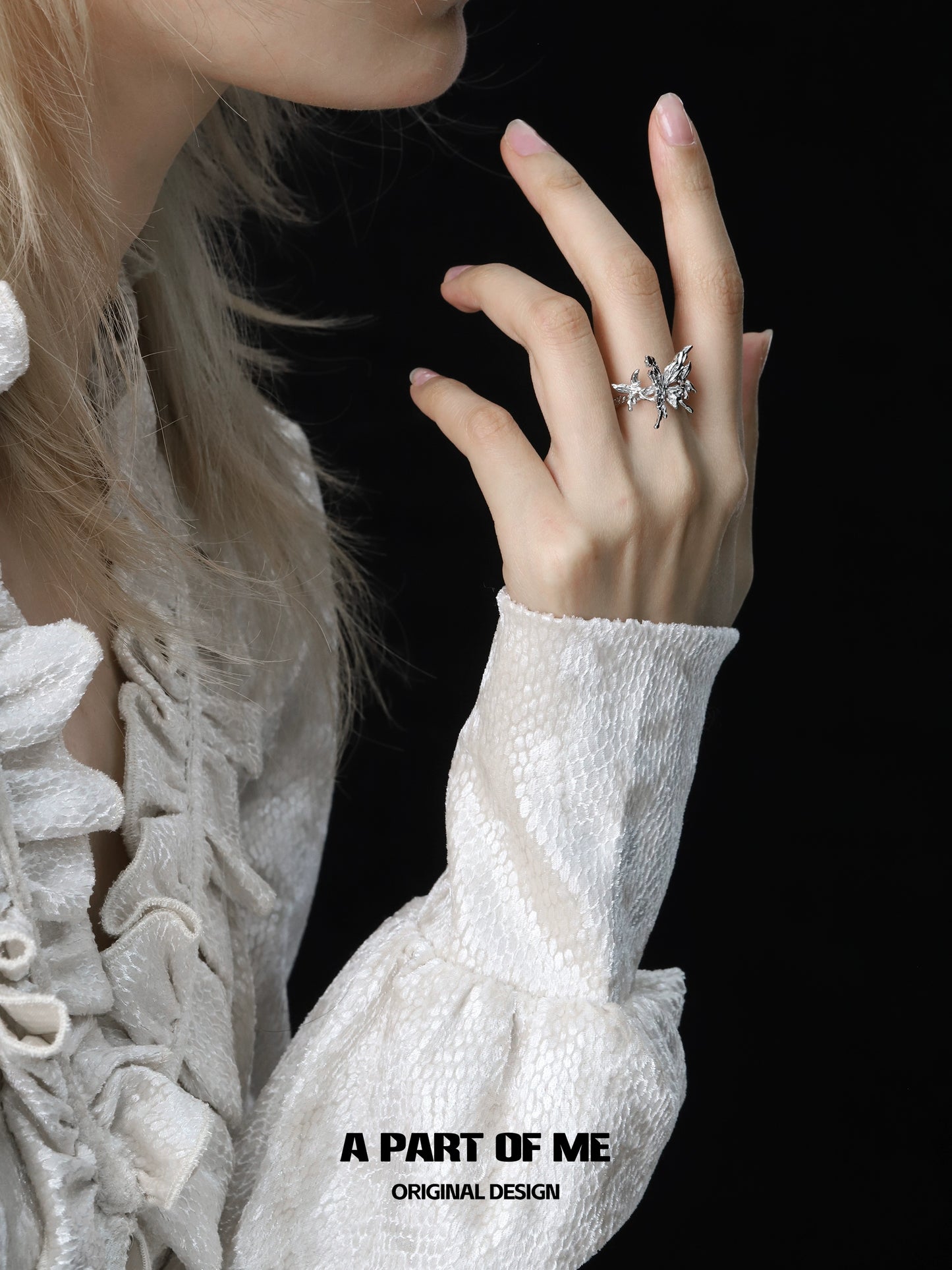 A PART OF ME butterfly punk ring showcased on a model's hand with elegant dress details