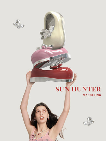 Colorful SUN HUNTER butterfly shoe rings displayed in a stylish stack with a model showing excitement