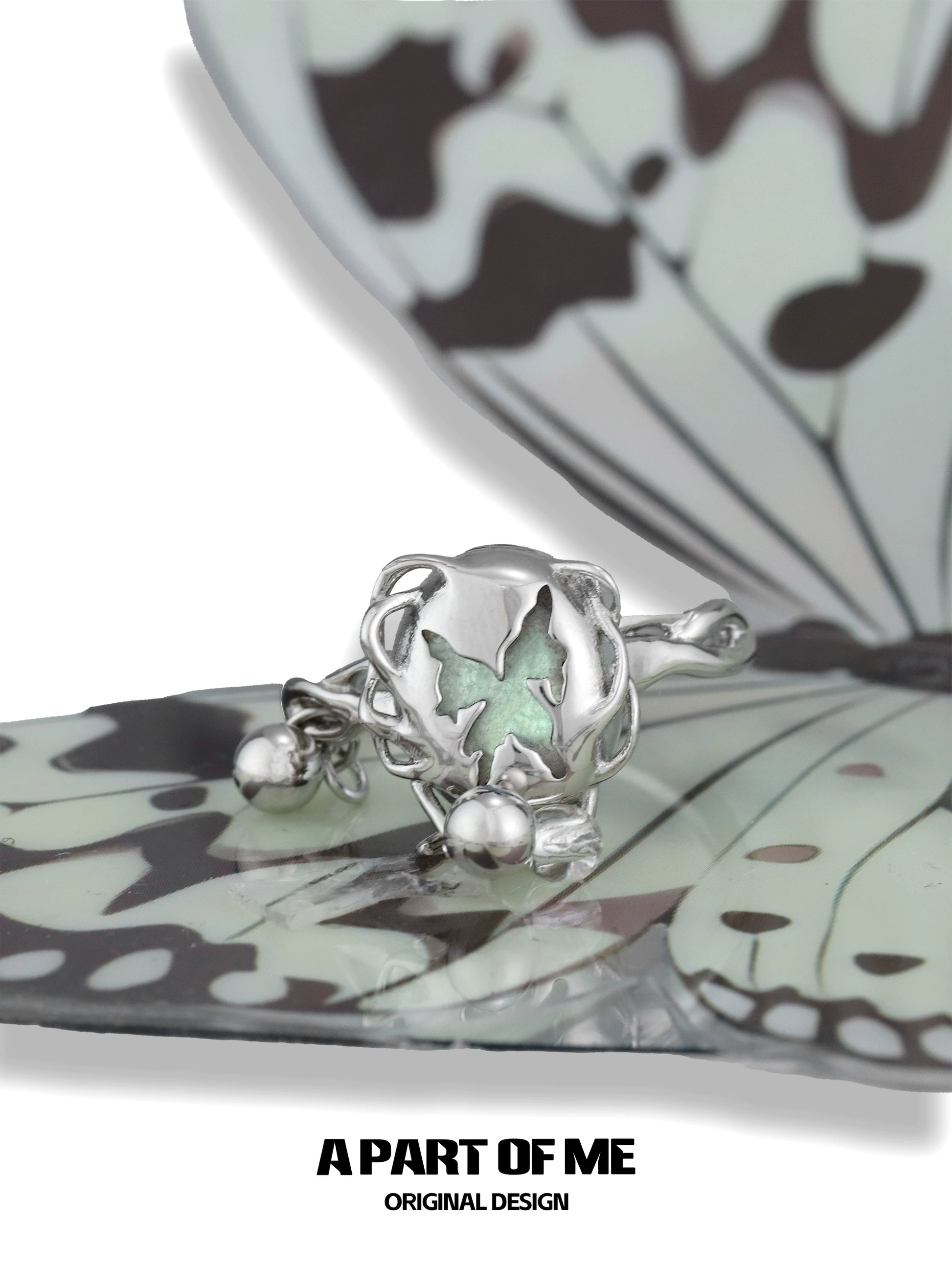 A PART OF ME butterfly silver ring featuring a delicate butterfly design with a green accent