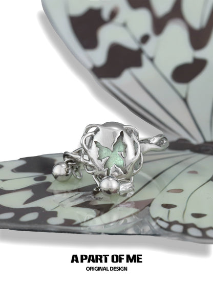 A PART OF ME butterfly silver ring featuring a delicate butterfly design with a green accent