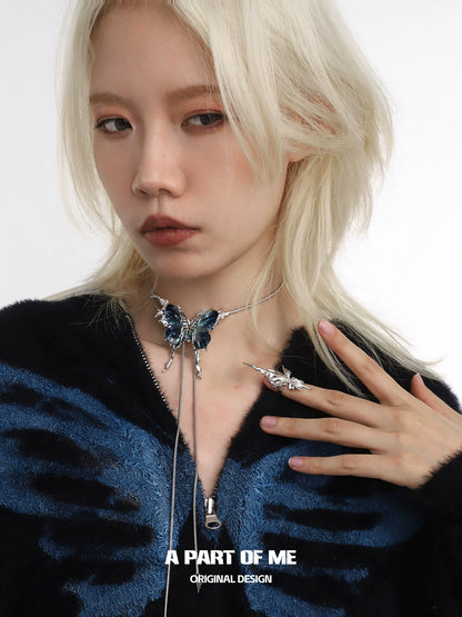 Stunning butterfly silver ring displayed on model's hand with a stylish choker and blue sweater