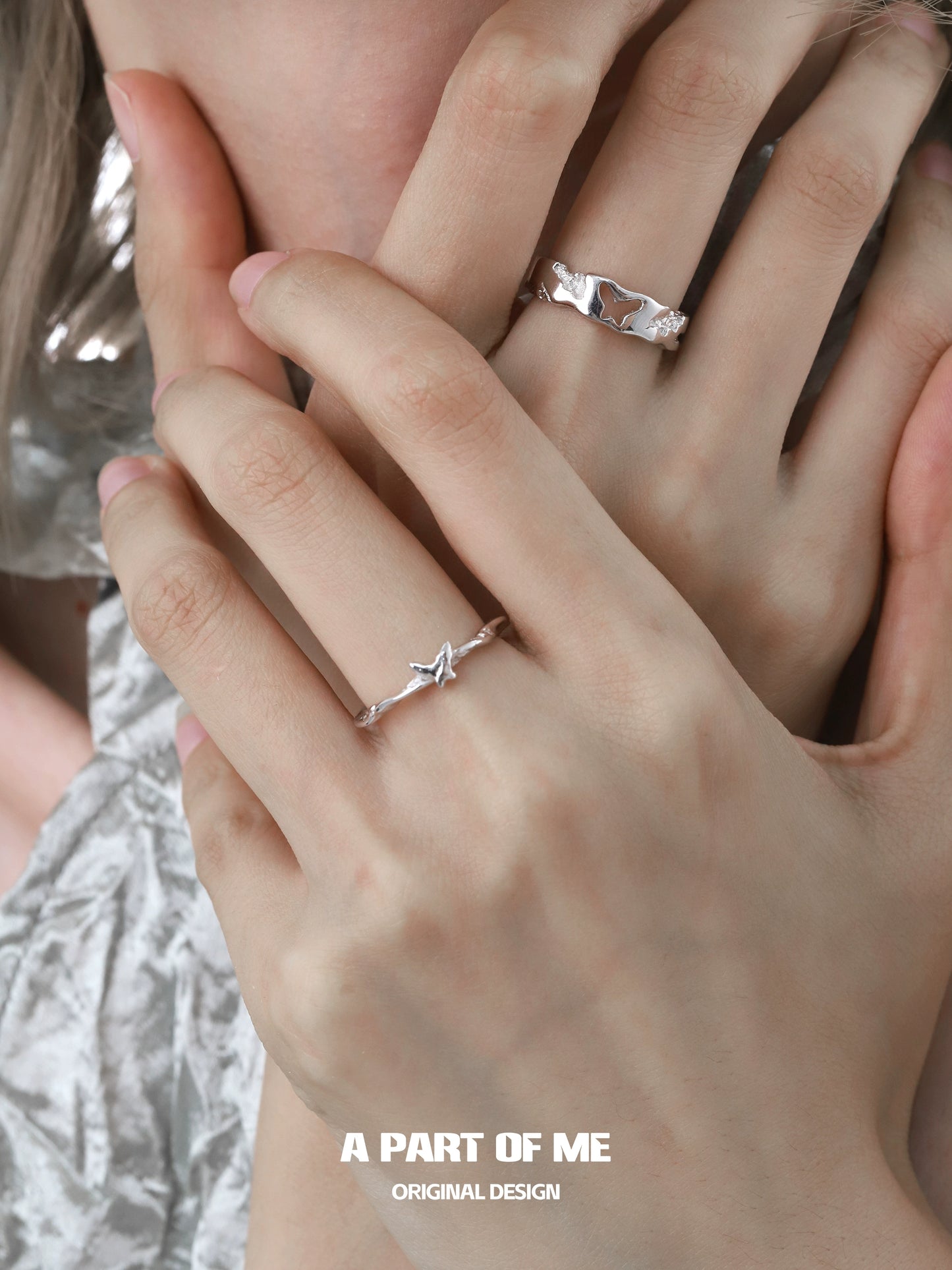 Elegant butterfly silver ring showcased on delicate hands with another silver ring