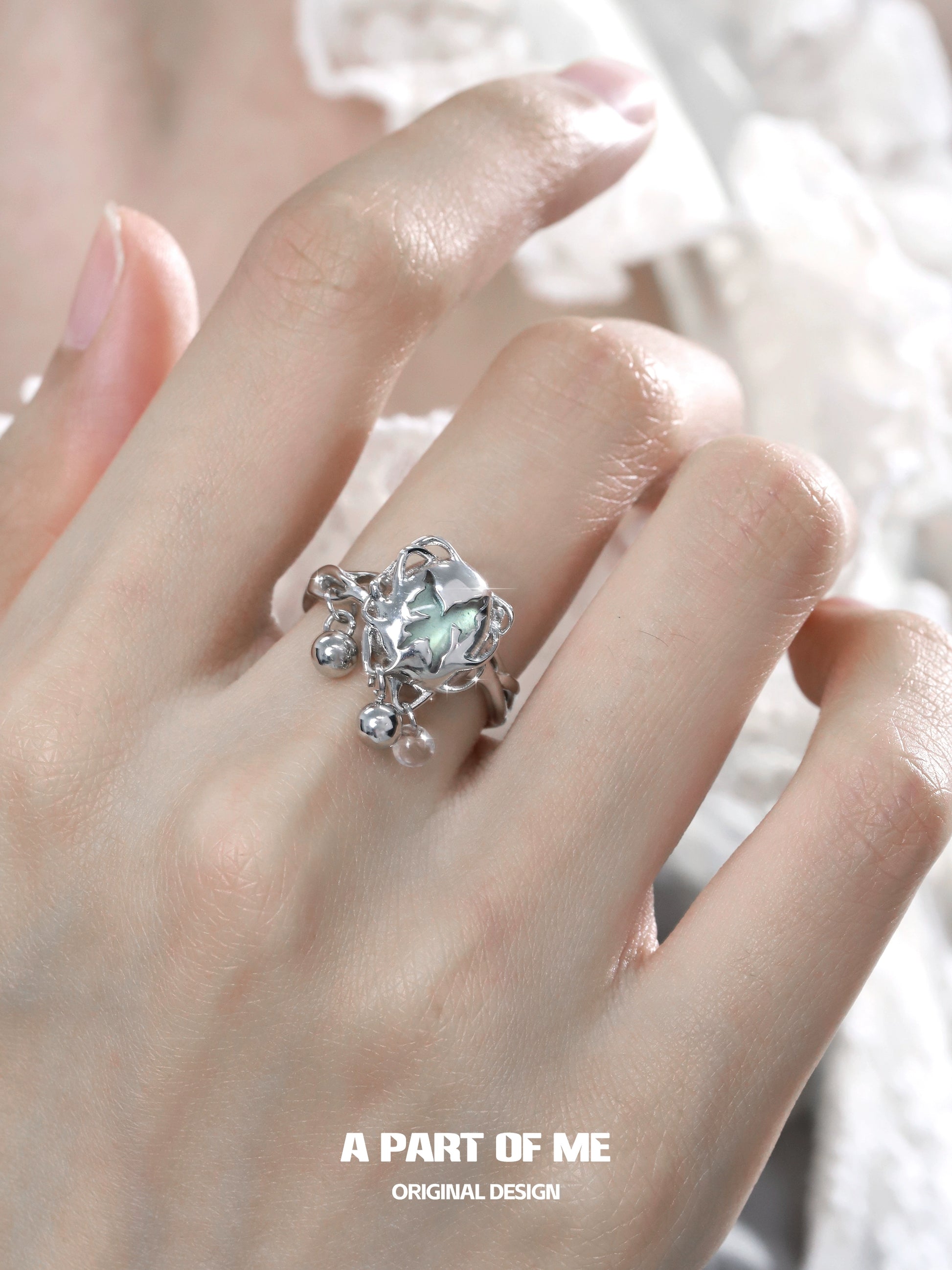 A Part of Me butterfly silver ring featuring a faceted gemstone and intricate detailing on a hand