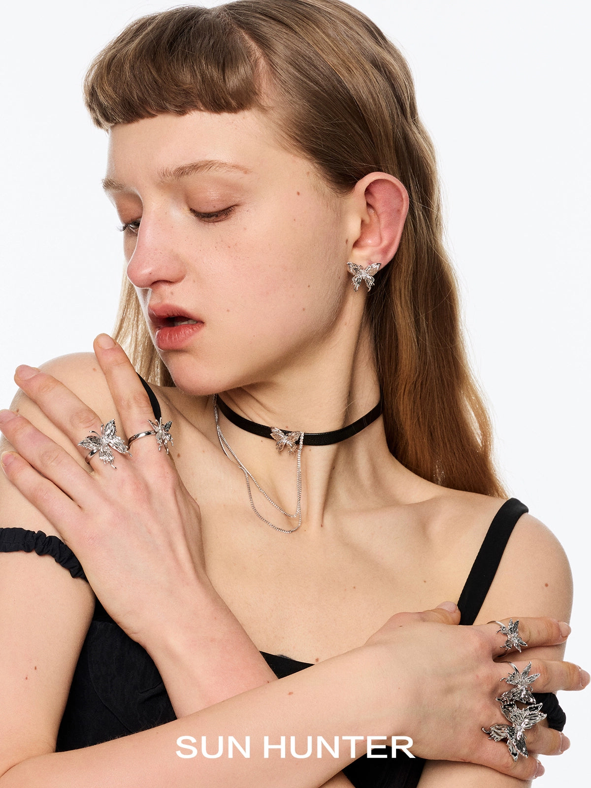 SUN HUNTER butterfly tassel ear cuffs showcased on model with matching rings and choker