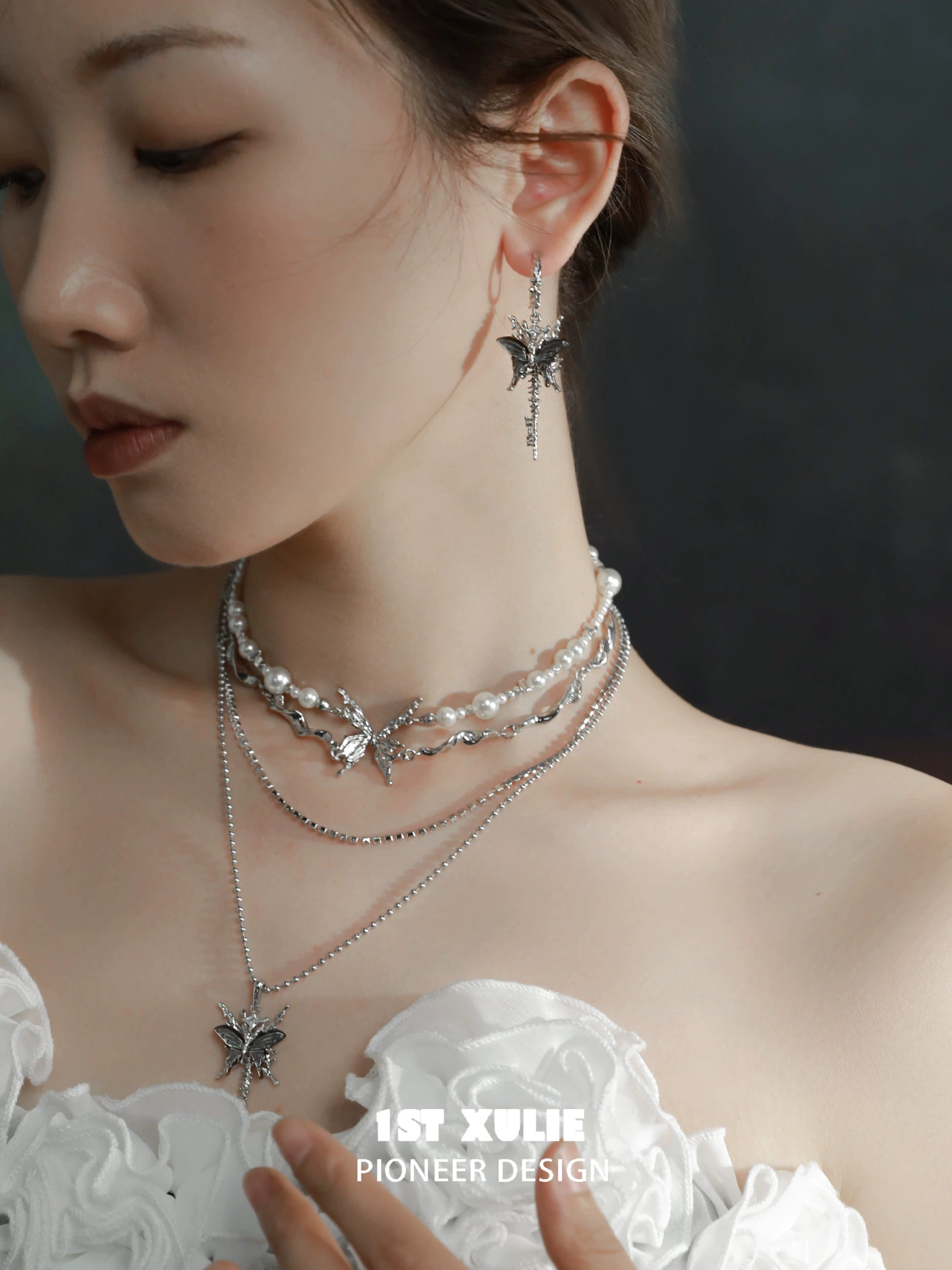 Elegant butterfly tassel shell earrings showcased with layered pearl necklaces for a chic look