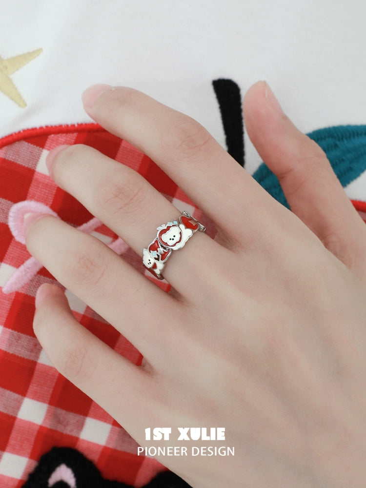 Cat and dog silver ring displayed on a hand with a stylish outfit background