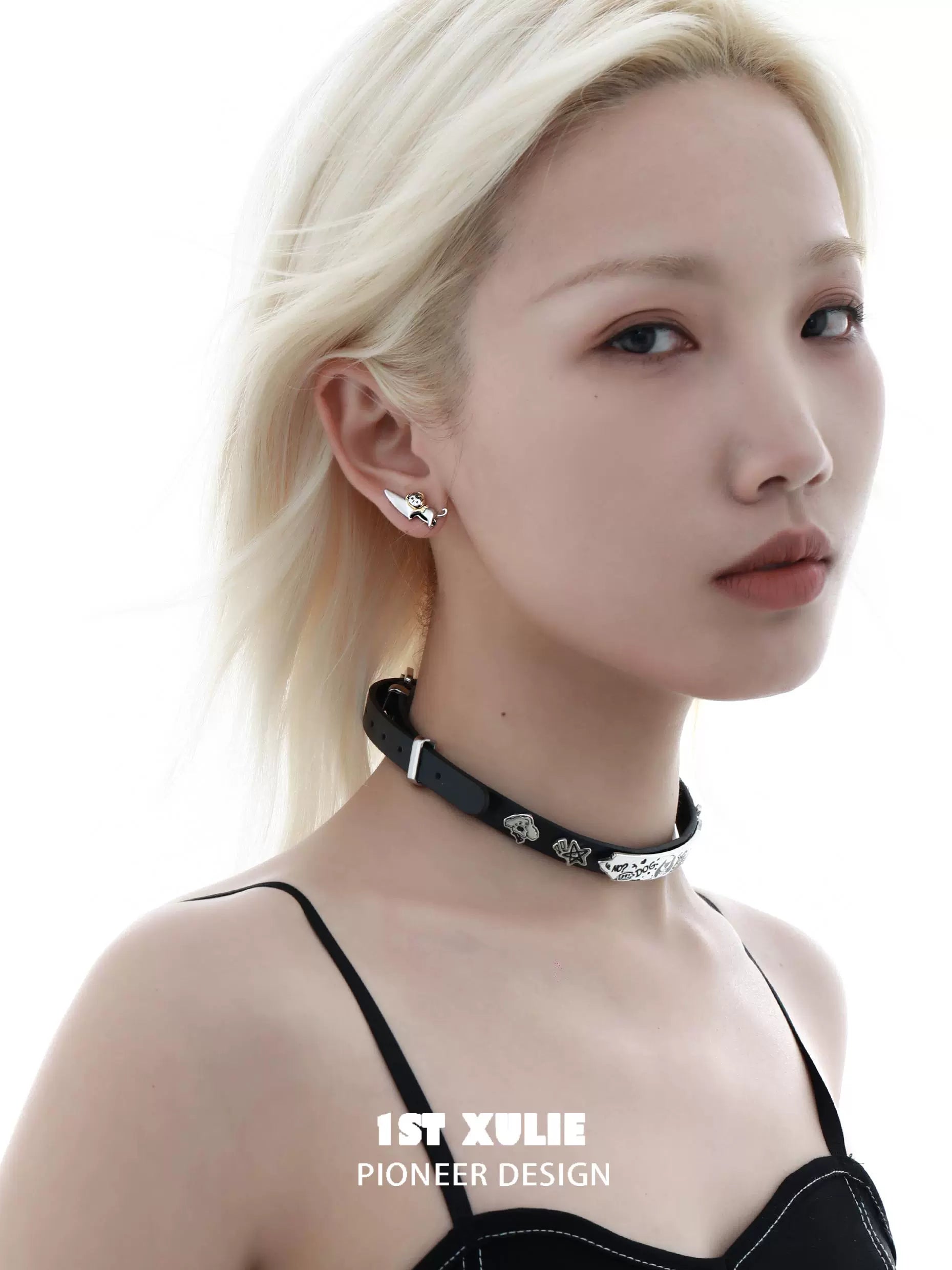 Stylish cat and dog stud earrings worn by a model with a sleek choker necklace