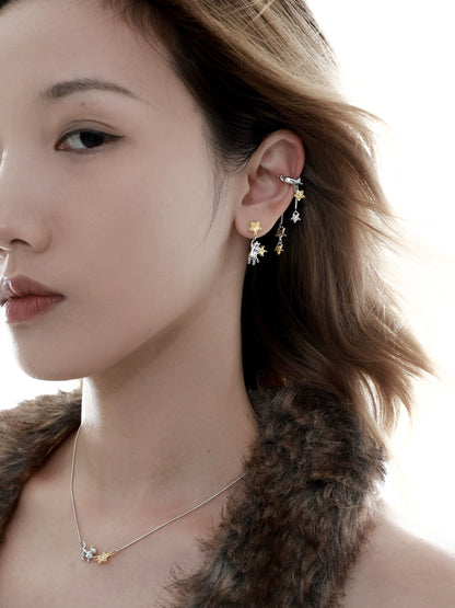 Stylish cat ear cuffs featuring playful designs, worn elegantly on a model's ear