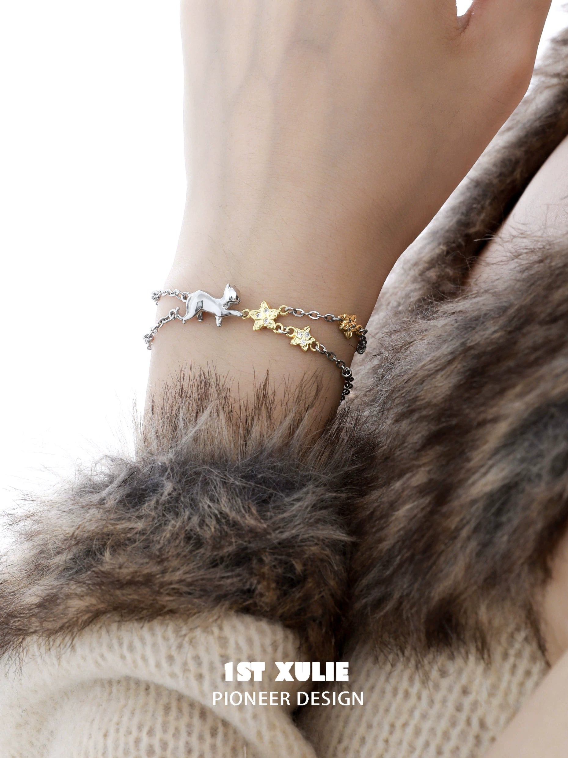 Silver and gold cat star bracelet featuring a playful cat and star charms for stylish pet lovers