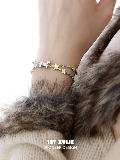 Silver and gold cat star bracelet featuring a playful cat and star charms for stylish pet lovers