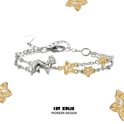 Delicate cat star bracelet featuring silver cat charm and gold stars with sparkling accents