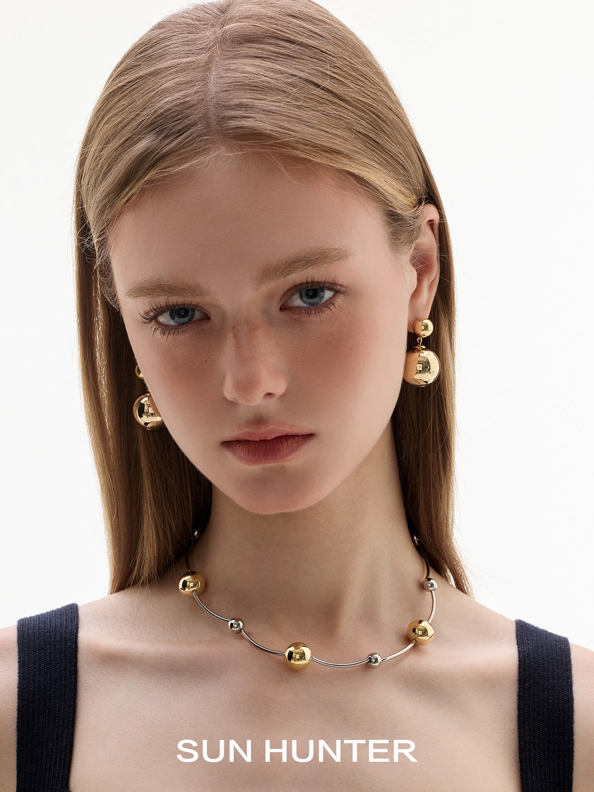 SUN HUNTER celestial planet gravity earrings featuring gold and silver spheres for a modern look