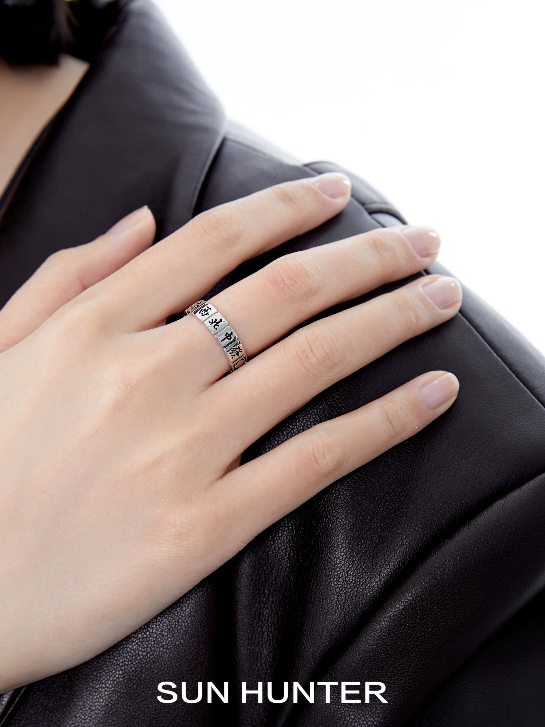Stylish SUN HUNTER Chinese Mahjong ring featuring intricate design on a sleek silver band
