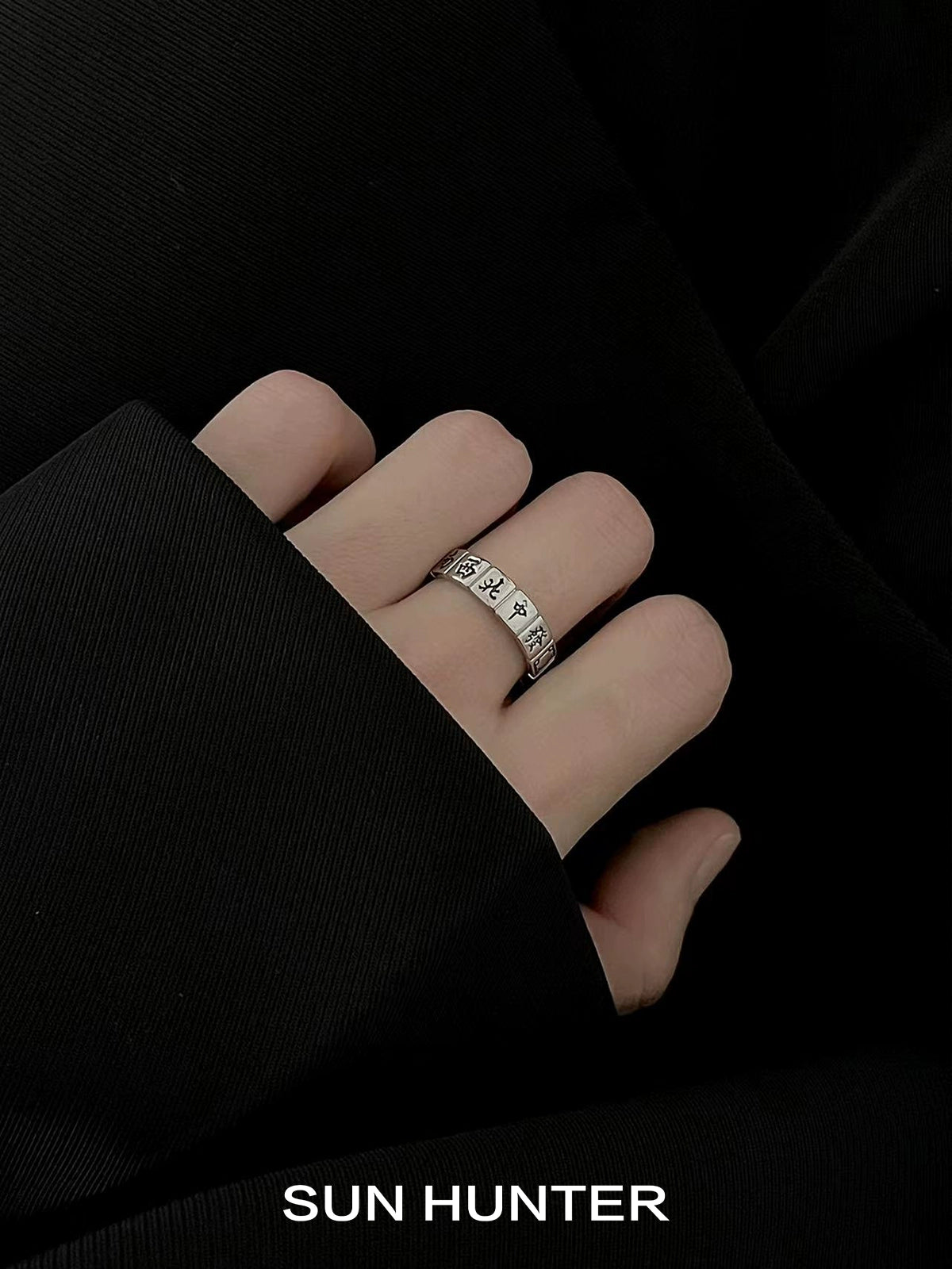 Elegant SUN HUNTER Chinese Mahjong ring displayed on a hand with dark attire